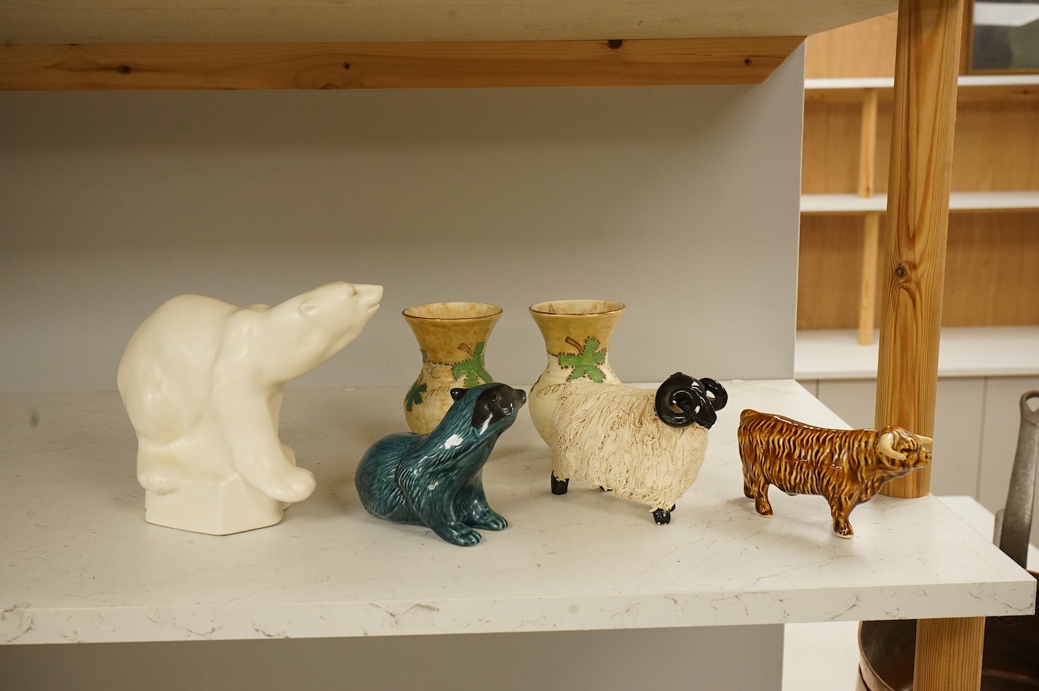 A Roy Smith Wedgwood polar bear, Poole pottery badger, Beswick bull and pig, together with other collectables, largest 17cm high